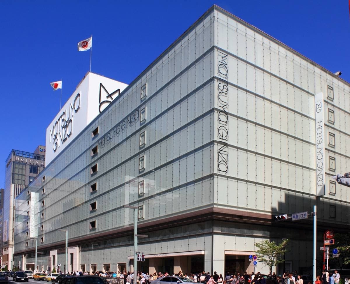 A department store with a pale grid facade on a Ginza corner