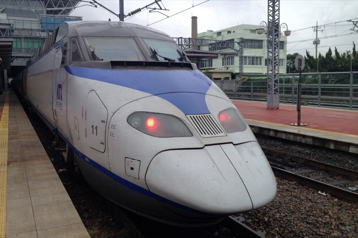 A KTX-I high-speed train standing at a platform at Busan Station.