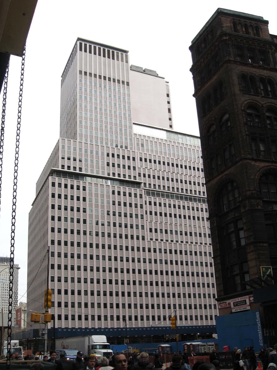 The tall stone-and-glass office block at 222 Broadway under a pale sky