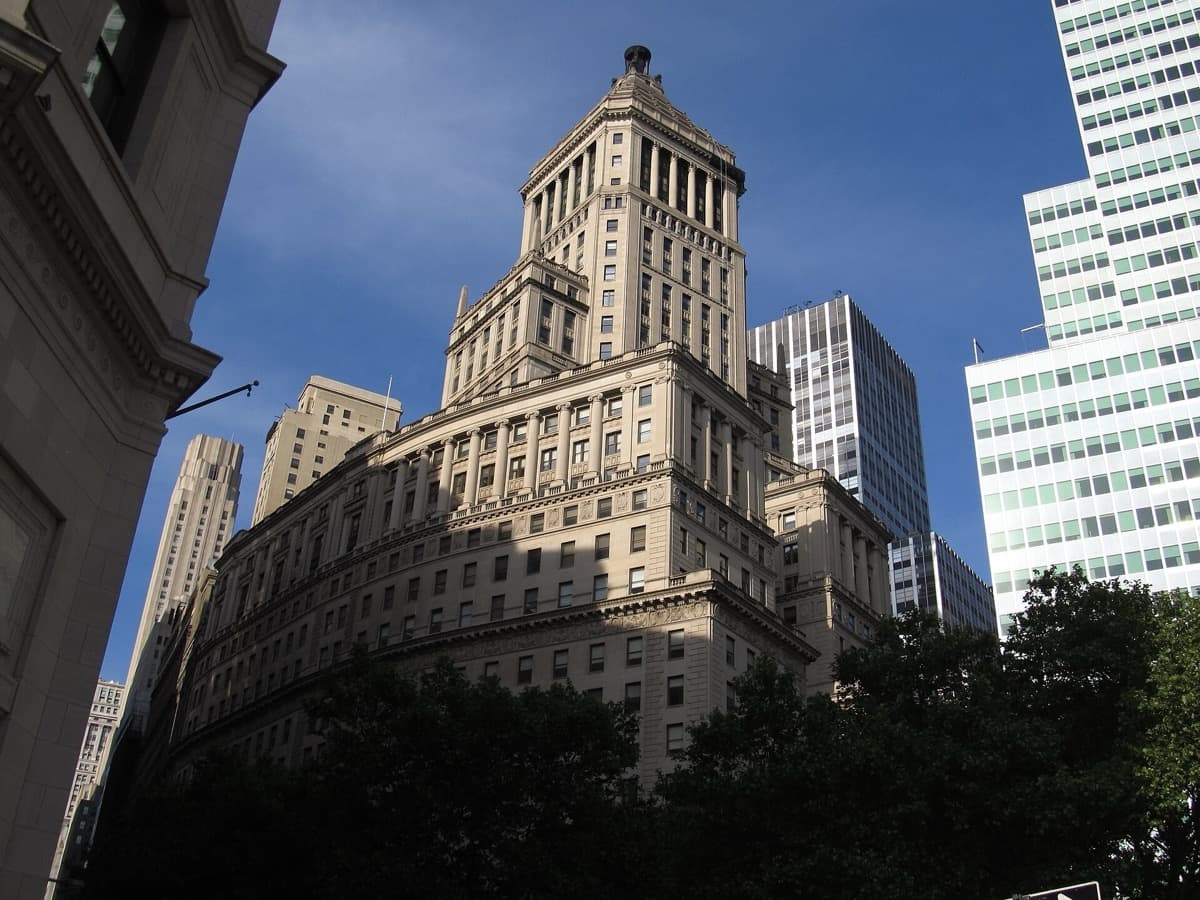 A tall curved stone tower on lower Broadway