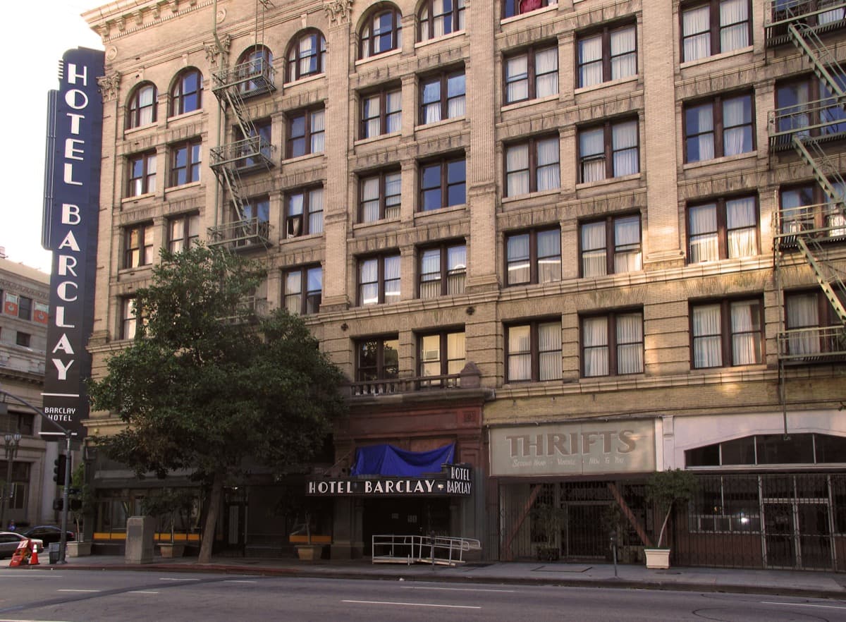 The corner of the Beaux-Arts Hotel Barclay with rows of tall windows