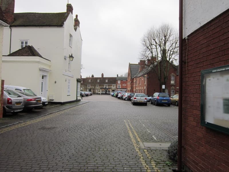 A town square in winter light with shopfronts and a pub