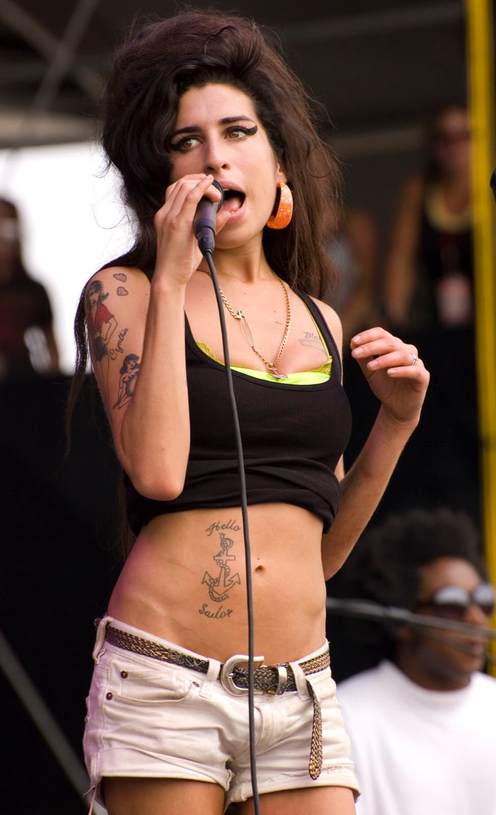 Amy Winehouse performing at an outdoor festival