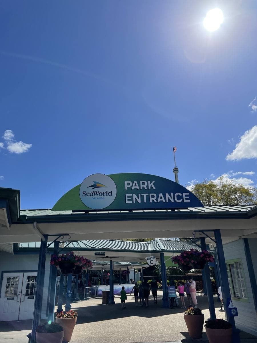 The SeaWorld Orlando entrance gate with a tall observation tower behind, 2021