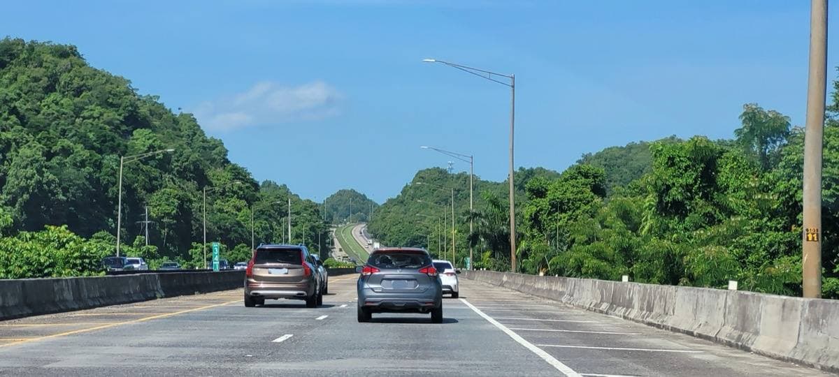 The PR-22 motorway passing green hills in Vega Baja