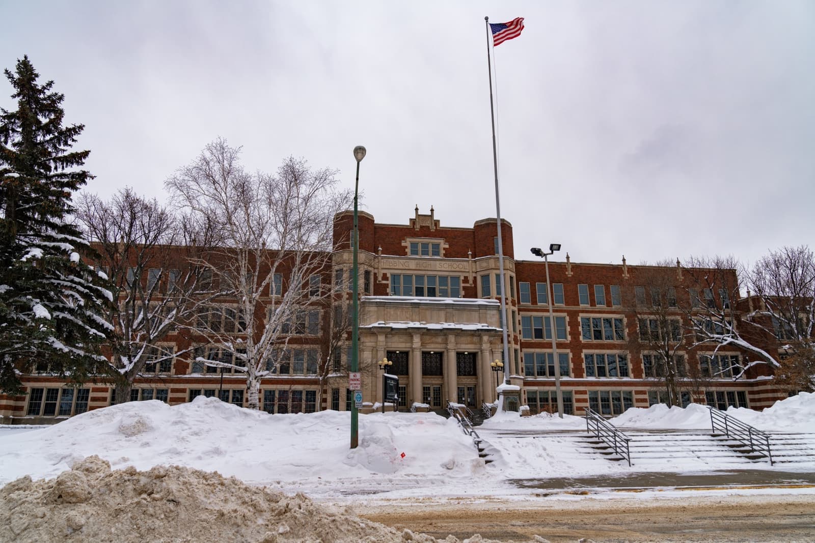 A long brick school with a central tower