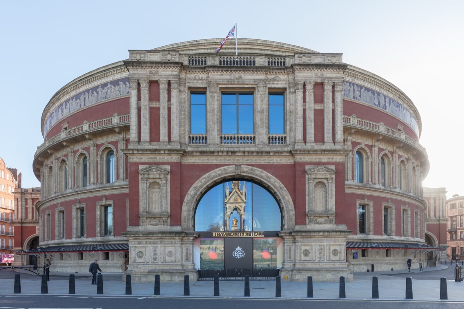 The round red-brick Royal Albert Hall under a blue sky