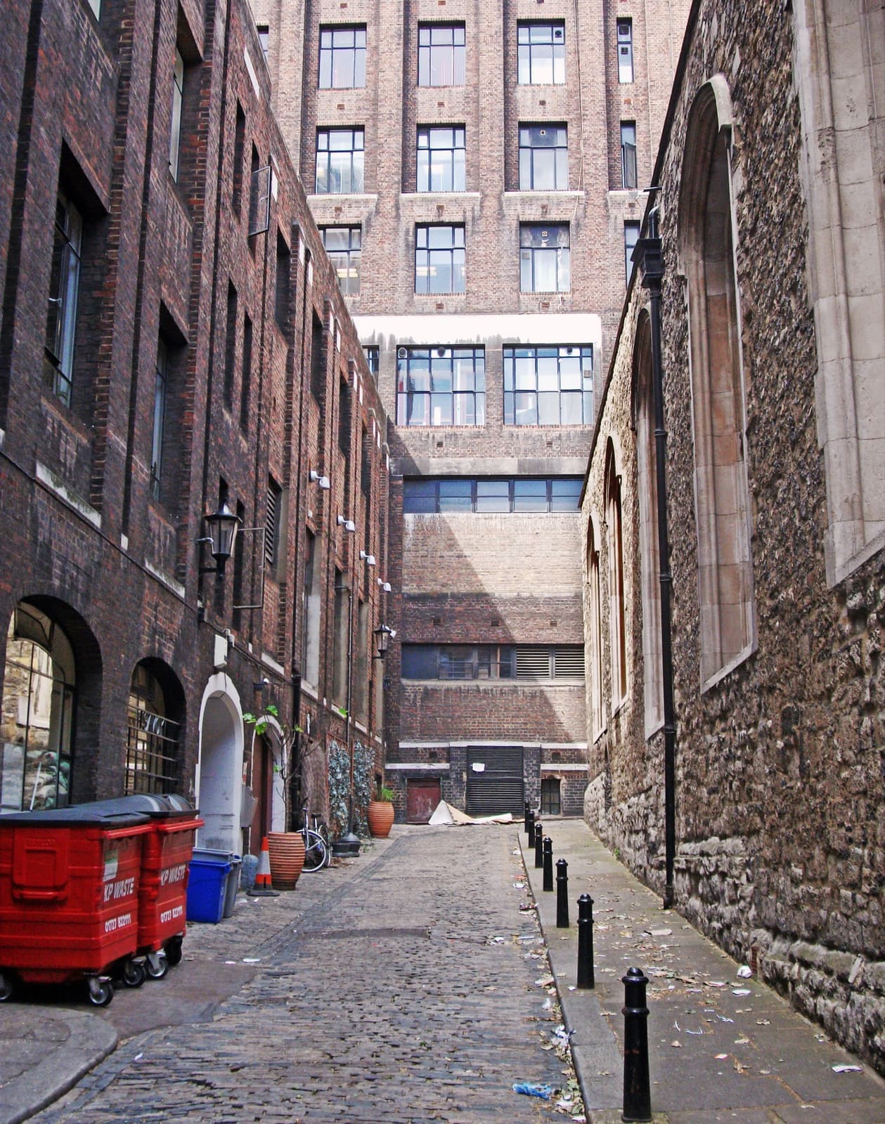 A narrow London alley running down between brick walls