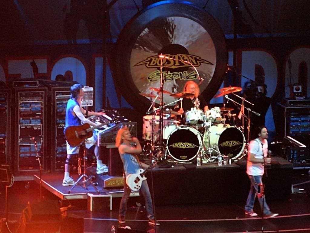 Boston playing on the TD Garden stage, a giant gong behind the drummer