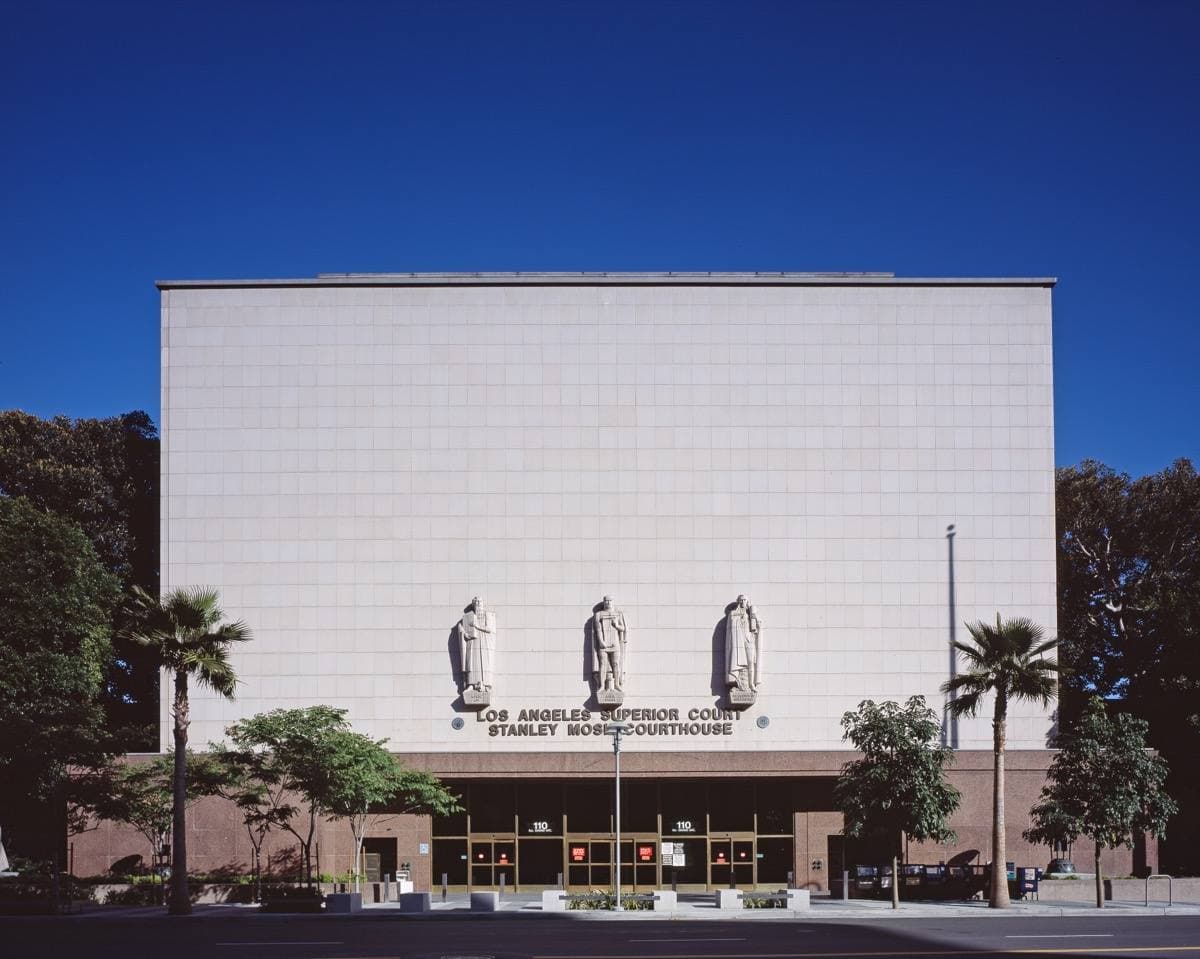 A long pale stone courthouse front with relief figures