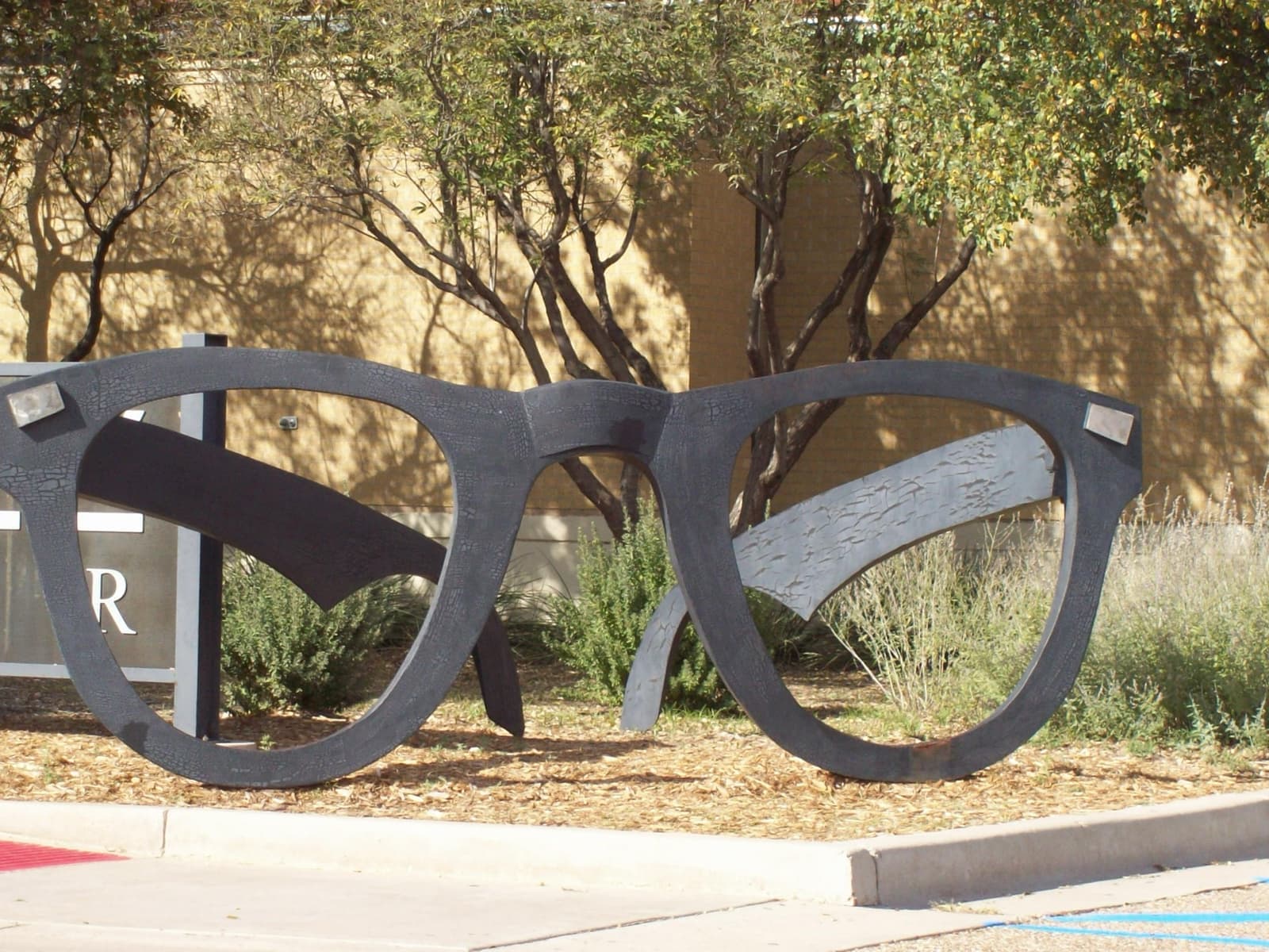 A huge sculpture of black horn-rimmed glasses on a plinth