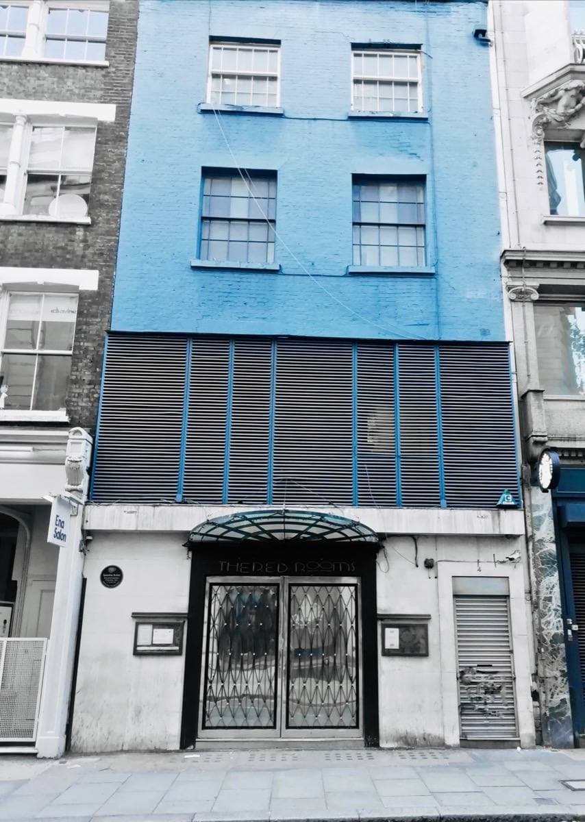A narrow blue-painted building front on Great Queen Street