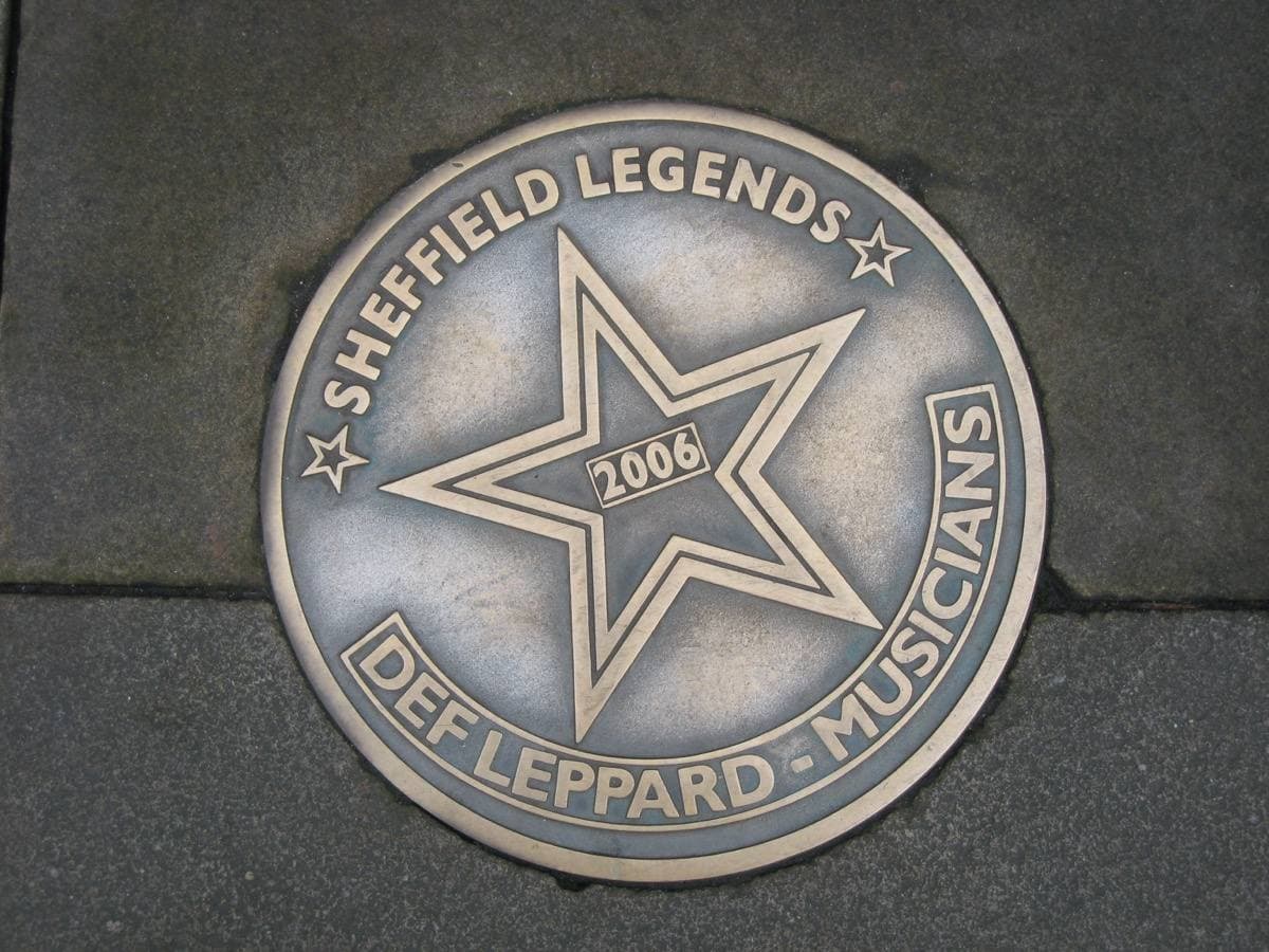 A metal star set in the pavement reading Def Leppard