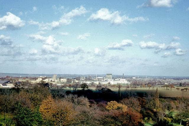A 1970s view across low housing to the tall blocks of a new town centre