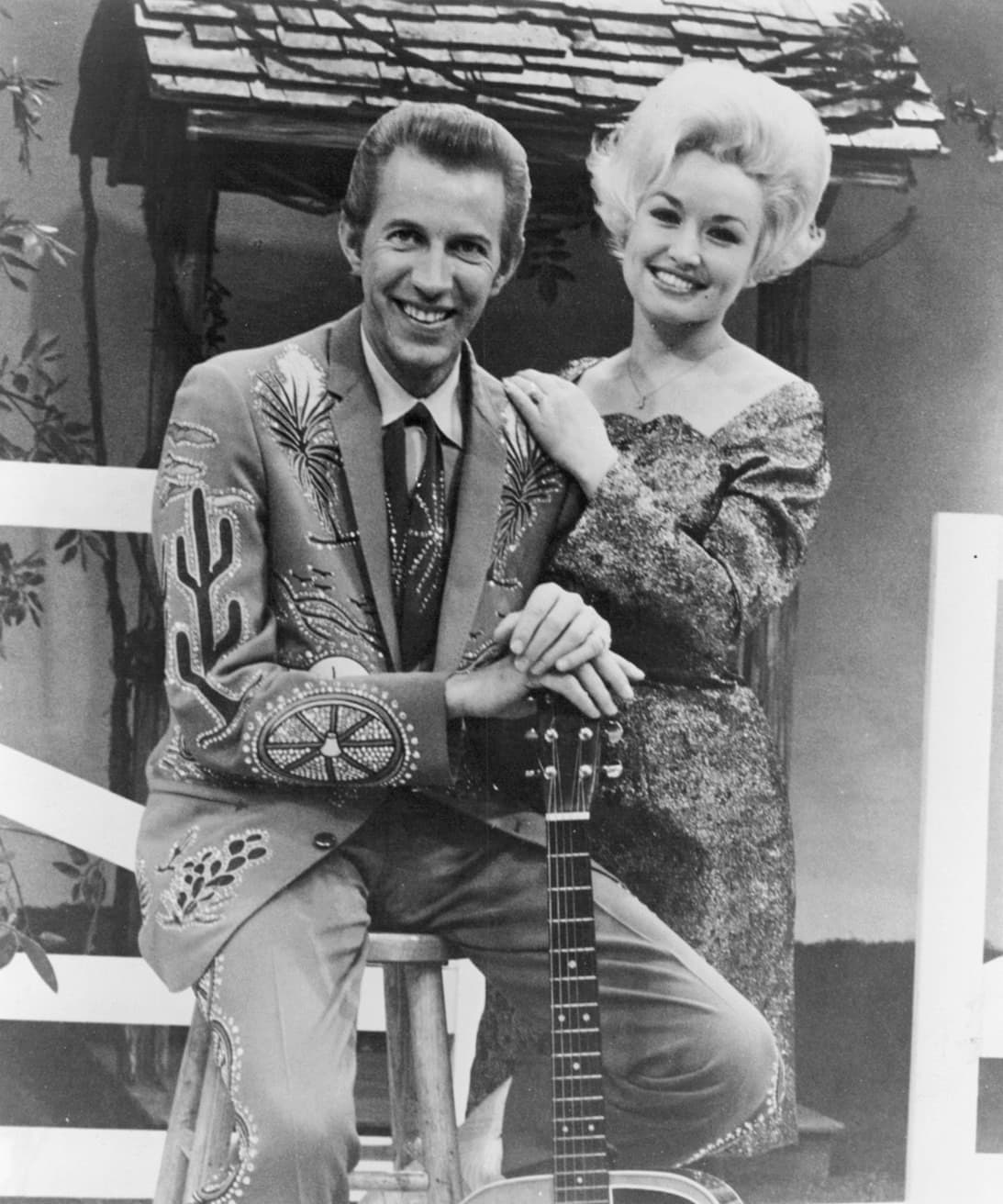 Porter Wagoner in a rhinestone suit beside Dolly Parton