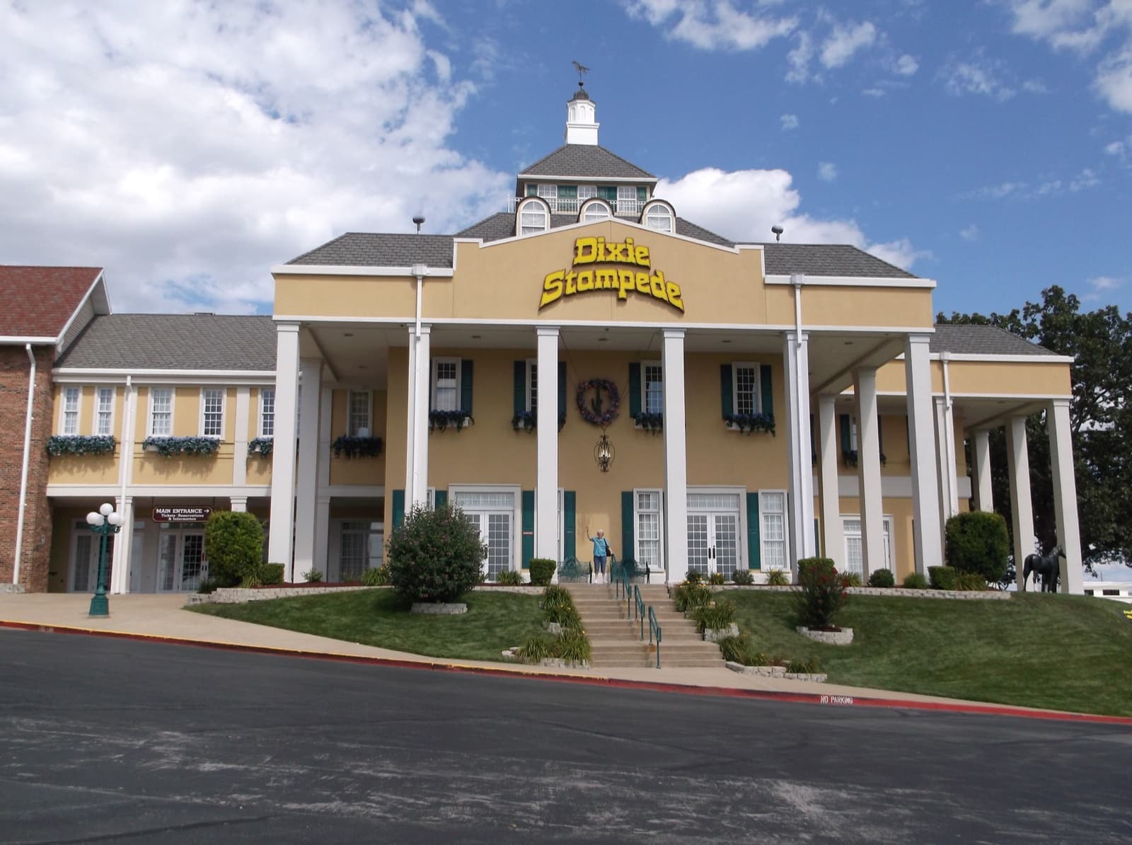 A white columned building with a yellow Stampede sign