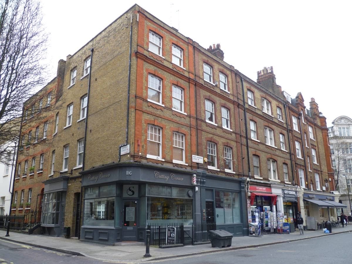 A London street corner of brick and stone buildings