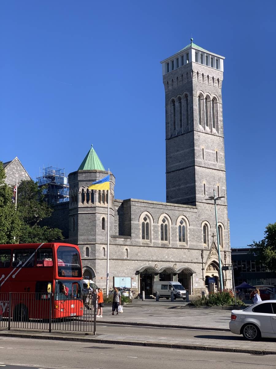 A Gothic Revival stone hall with a tall square tower