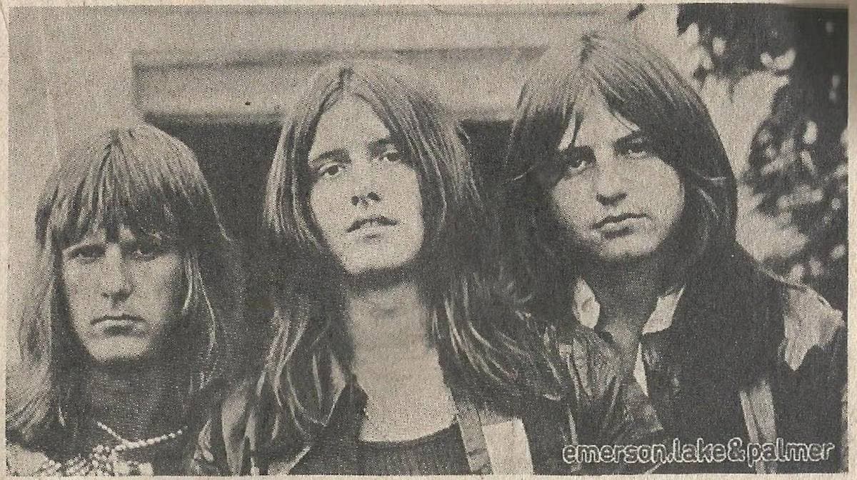 Three young men with long hair looking into the camera, in a grainy newsprint photograph