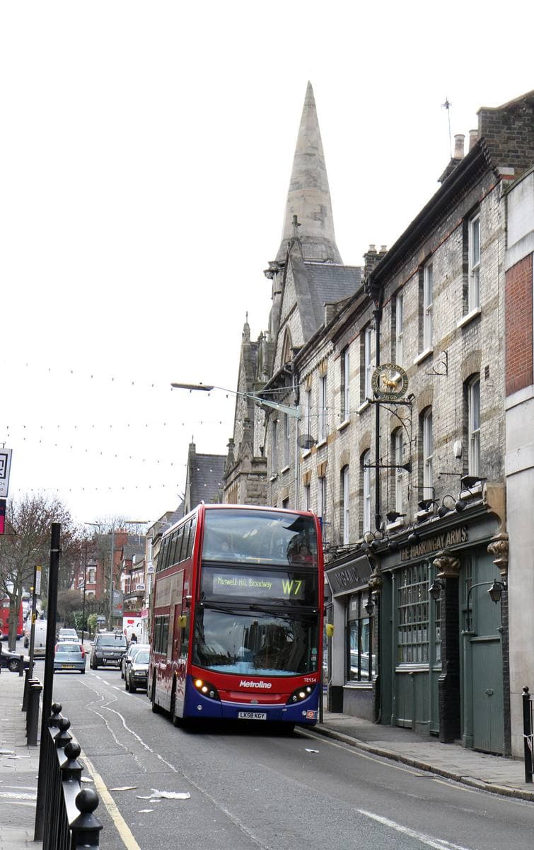 A bus coming down Crouch Hill between houses