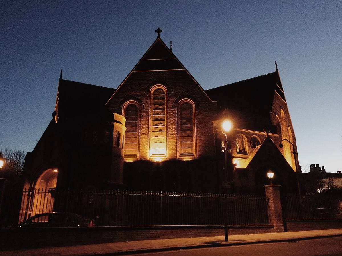 A red-brick Victorian hall lit up at night