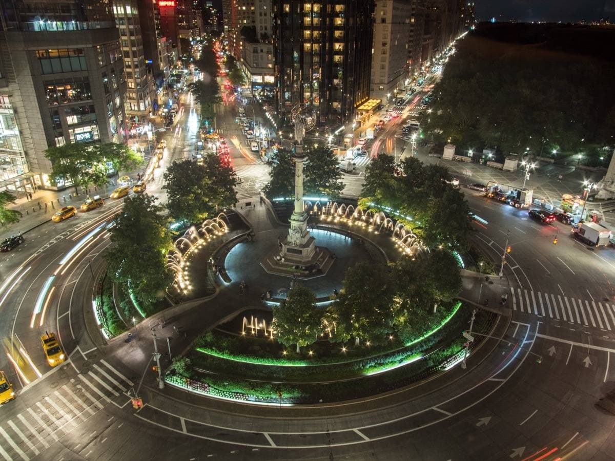 Columbus Circle at night with traffic and lit towers