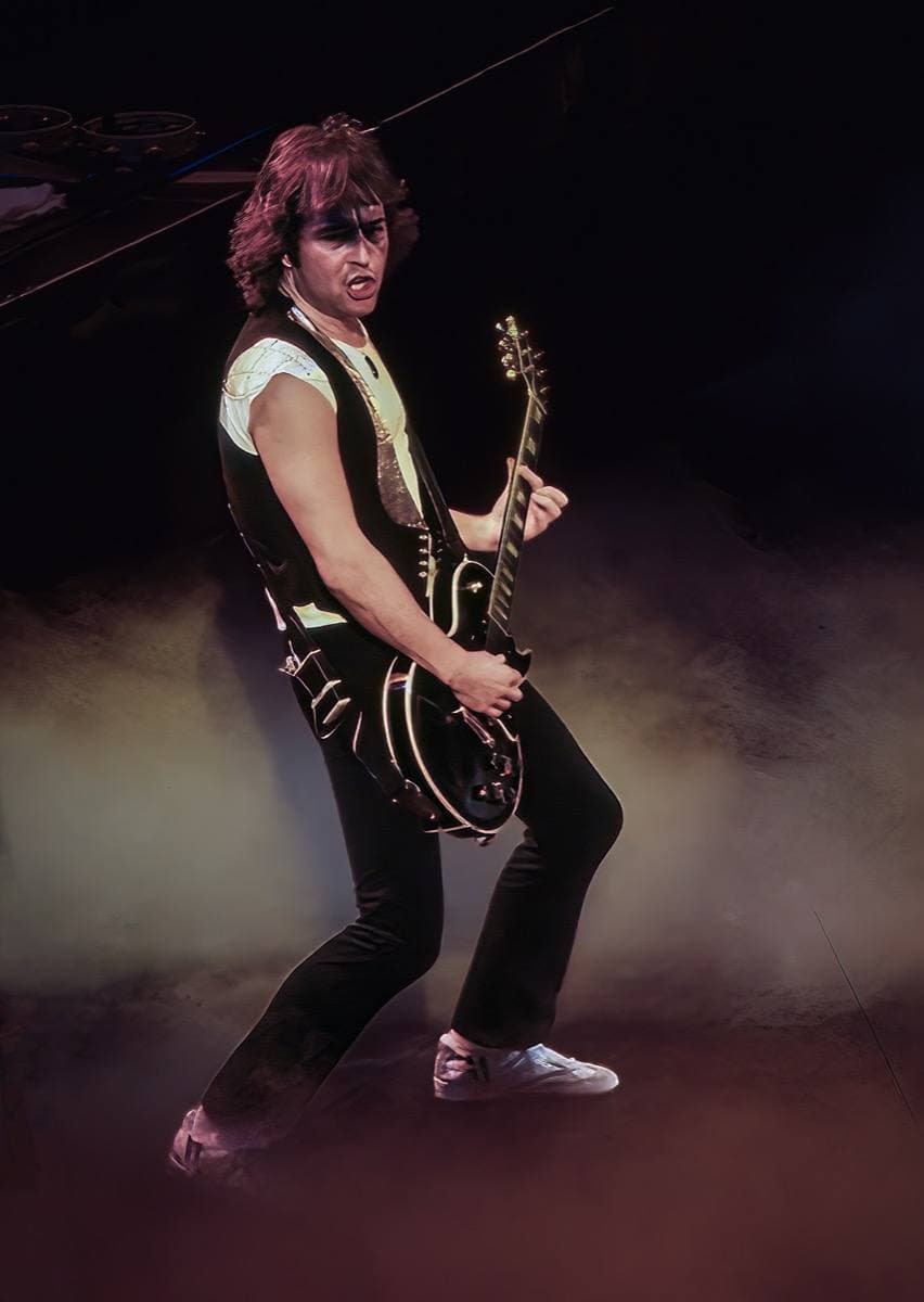 Mick Jones playing guitar on stage in 1979