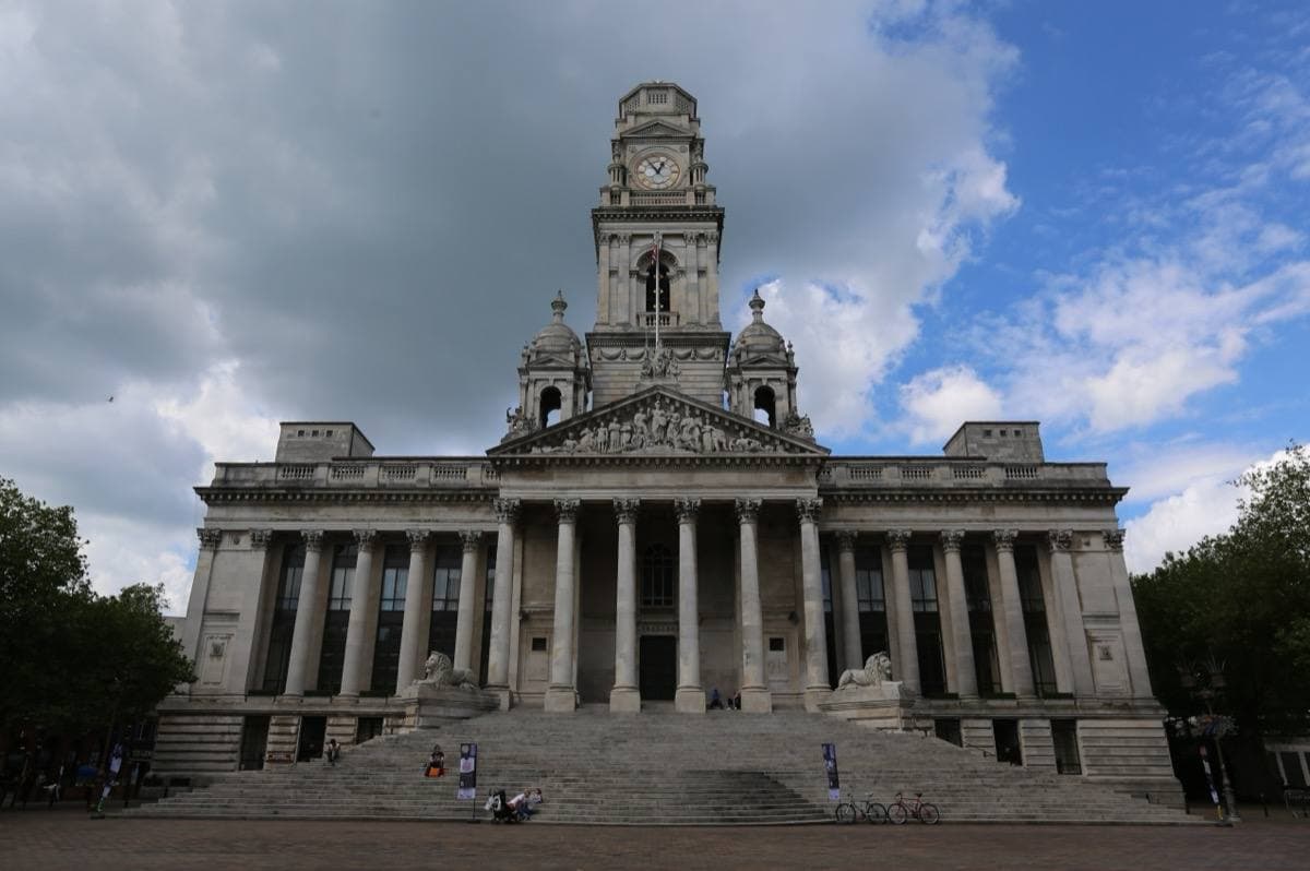 The columned front of Portsmouth Guildhall with its clock tower