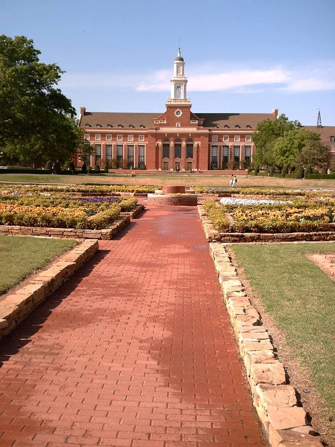 A red-brick Georgian library with a white cupola and a lawn in front