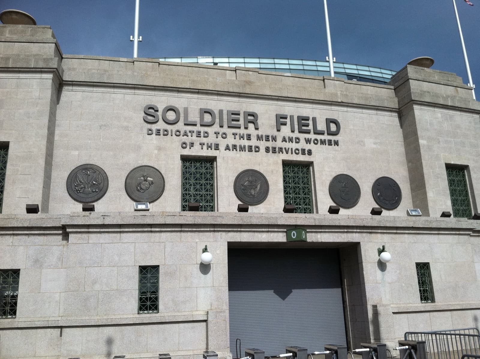 The colonnaded stone entrance of Soldier Field with its name carved above