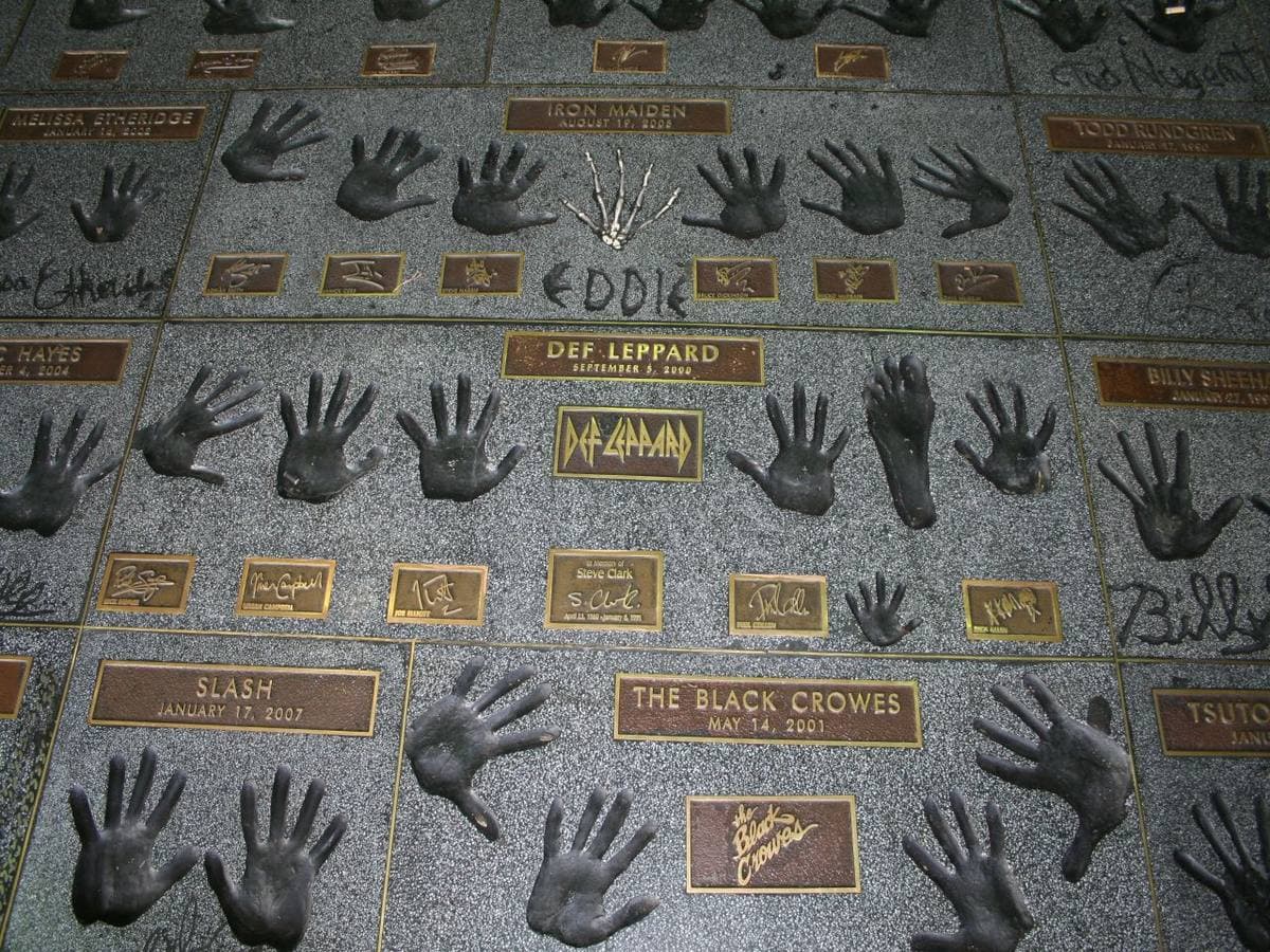 Bronze plaques with handprints set in the pavement outside a guitar shop