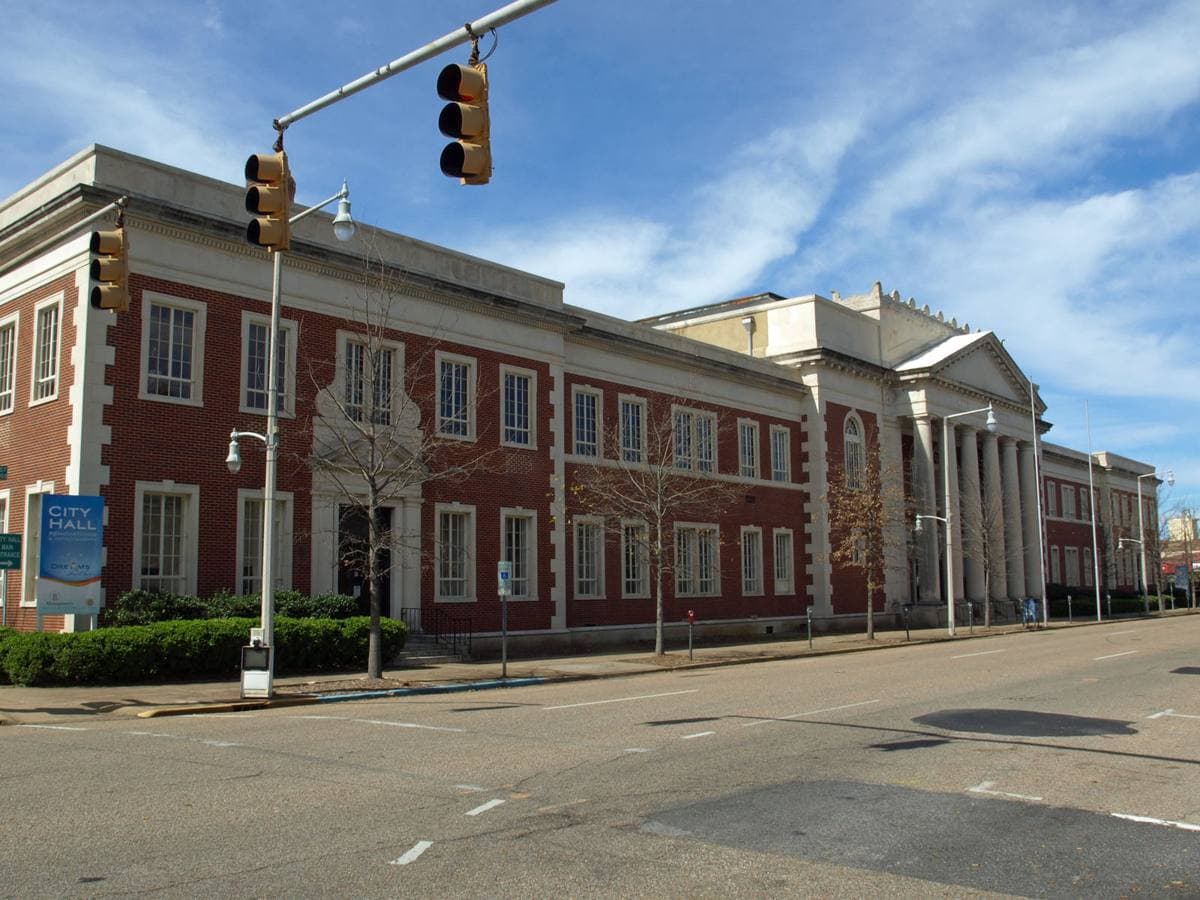 A pale classical civic building with tall columns