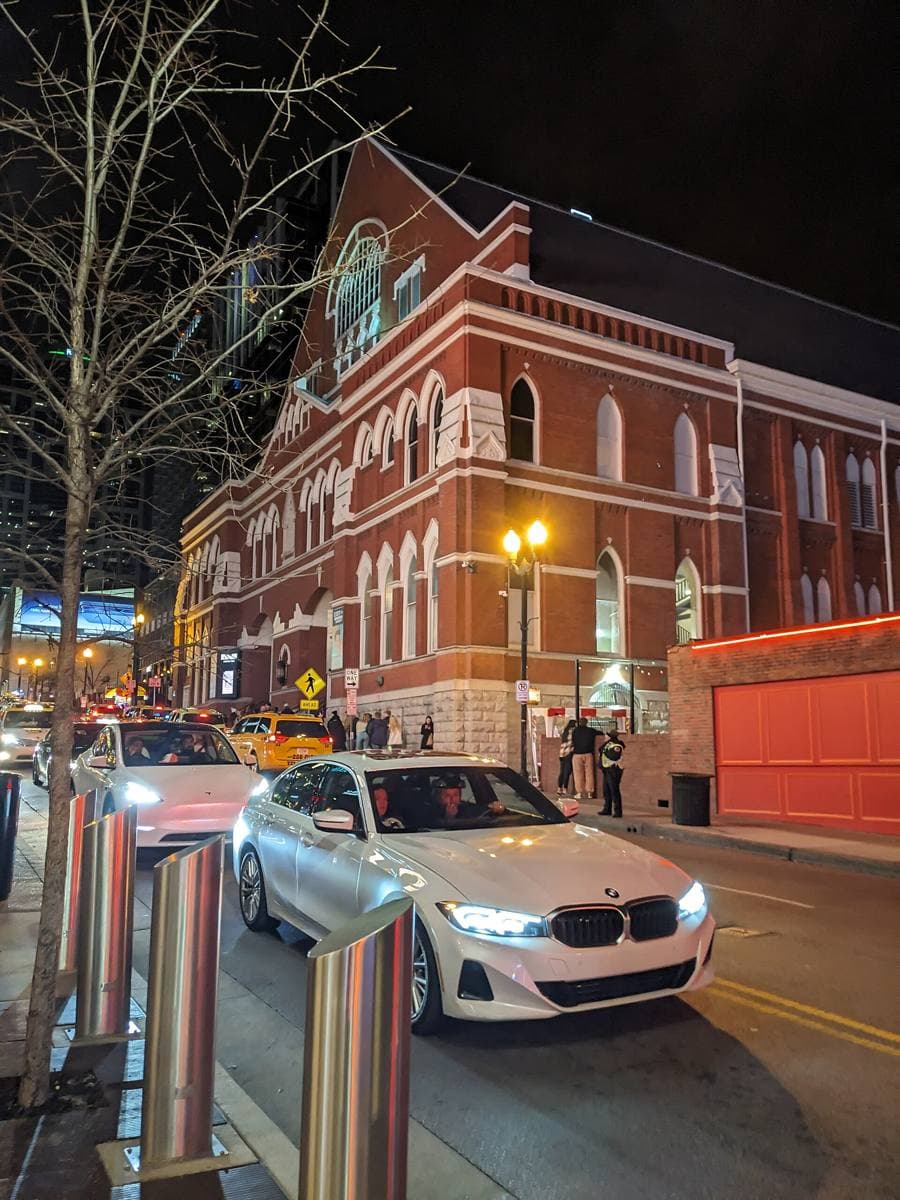 The red-brick Gothic front of the Ryman Auditorium lit at night