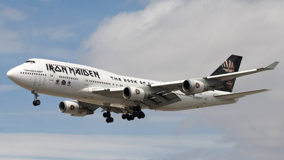 A four-engined jumbo jet on approach against cloud