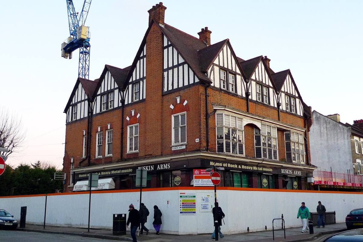 A gabled, half-timbered brick pub on a street corner