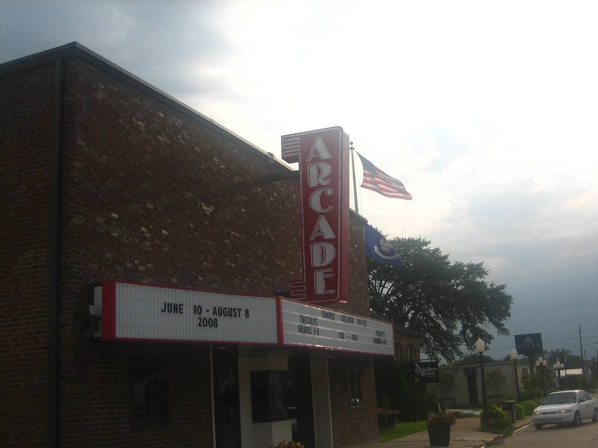 A small-town theatre with an upright ARCADE sign