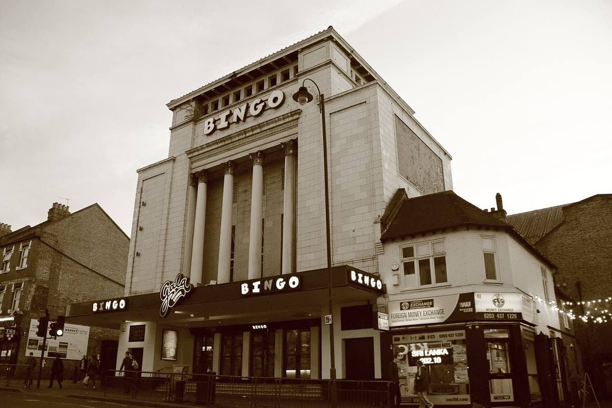 A cinema front with tall arched windows on a high street