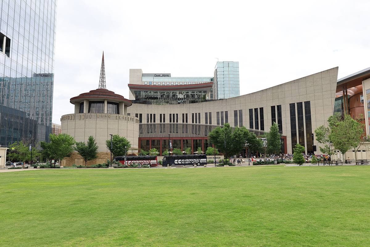 The museum seen across a lawn, a long curved building with a round rotunda