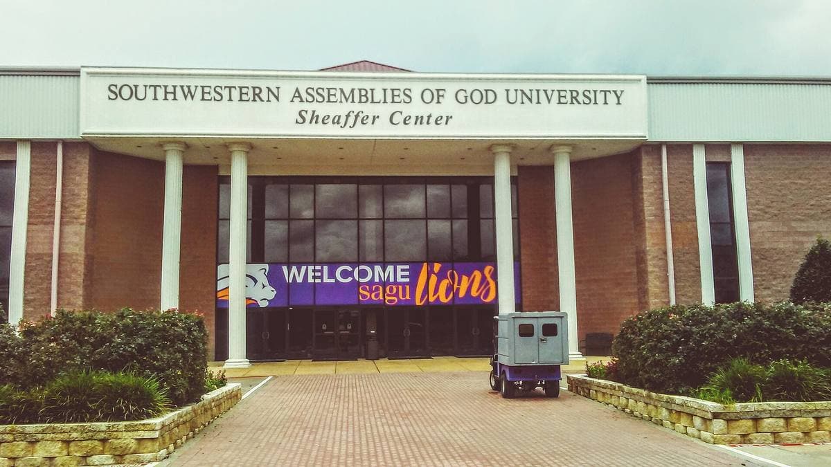 A low brick college building with a sign for Southwestern Assemblies of God University