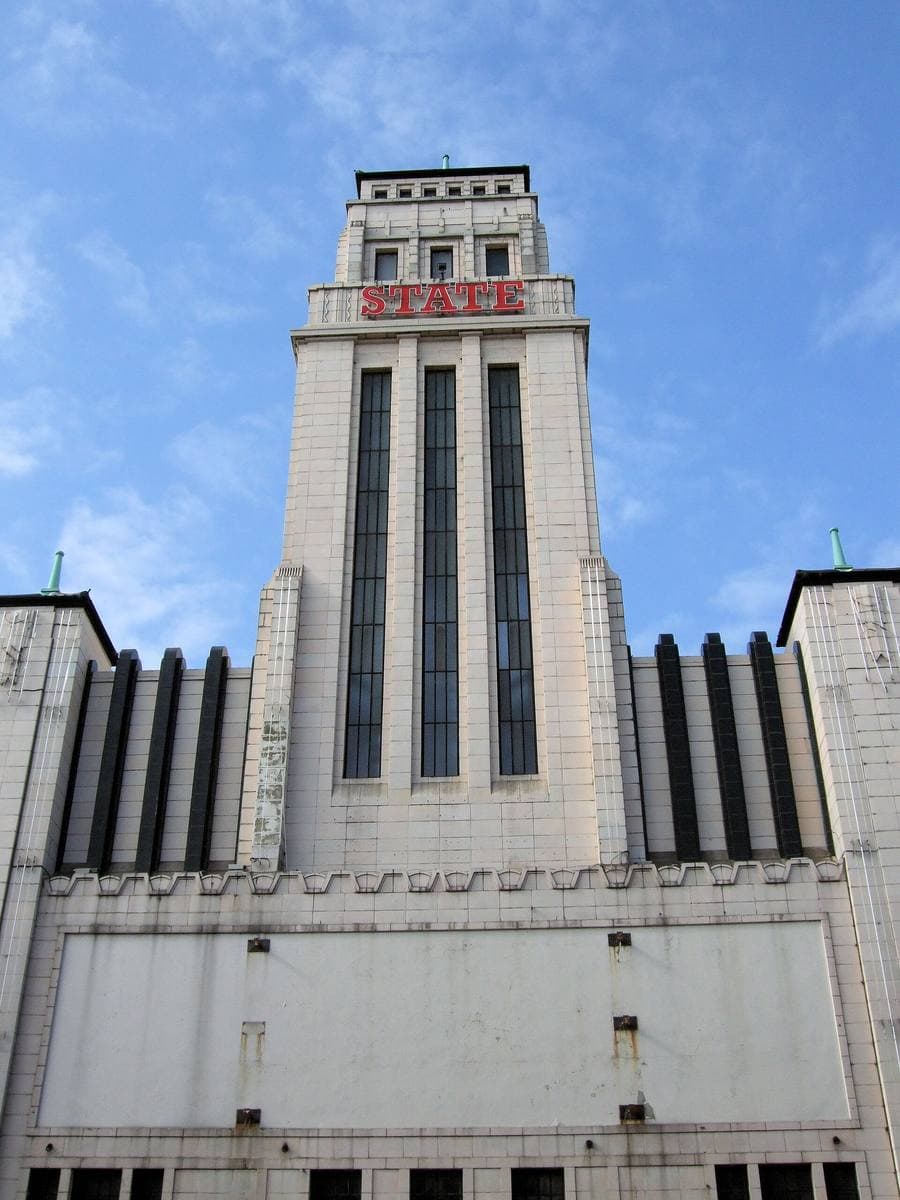A tall pale art deco tower with the word STATE at the top