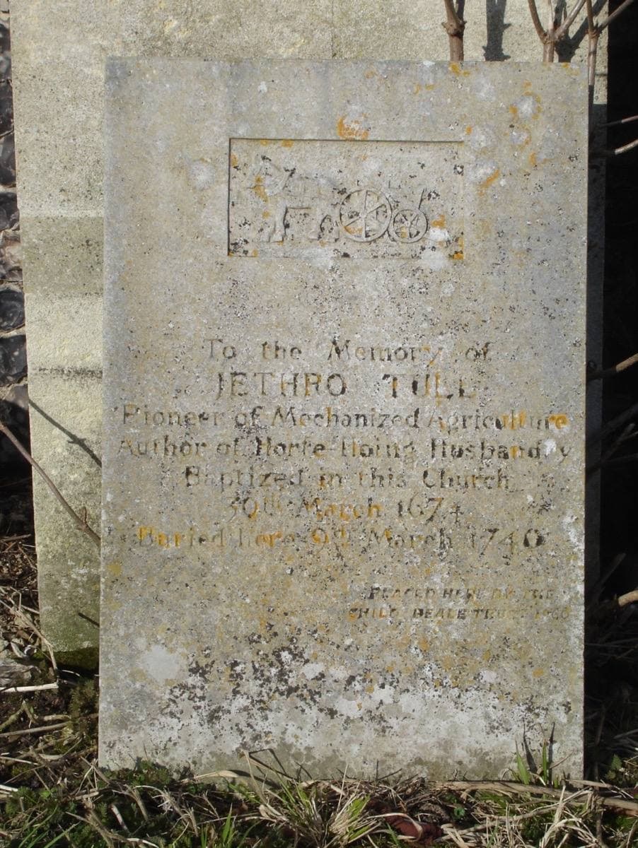 A stone grave slab set against a church wall