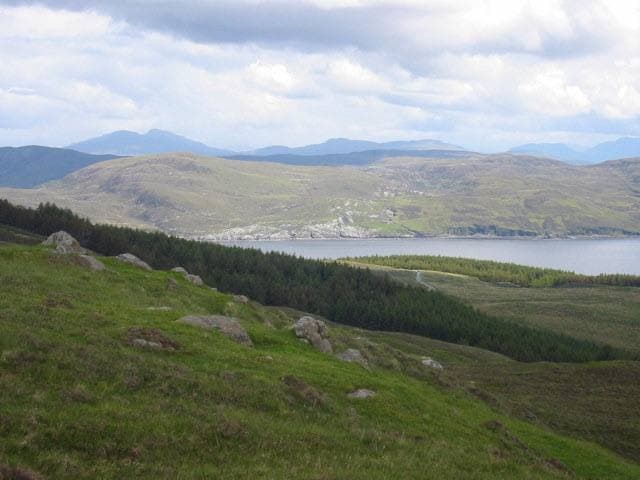 Moorland with blocks of forestry and a loch beyond