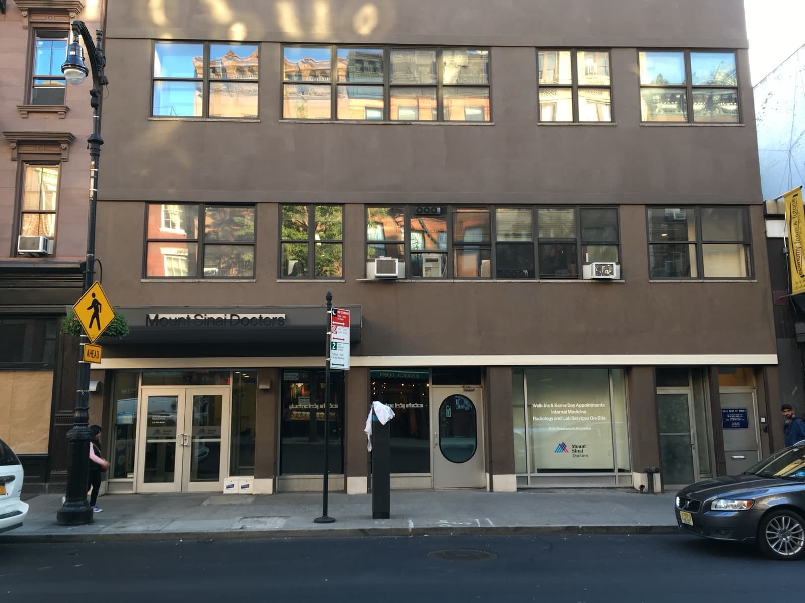 A low building on West 8th Street with a curved brick front