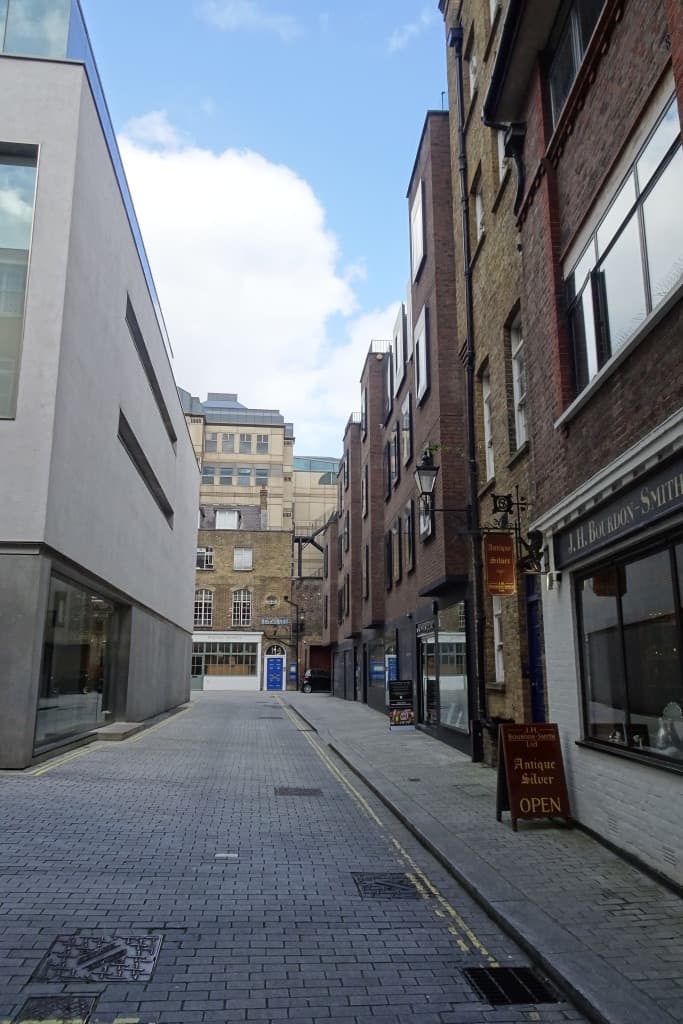 A narrow paved yard between brick buildings