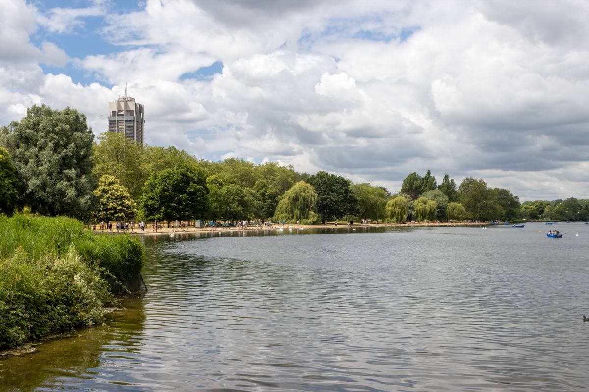 The Serpentine lake in Hyde Park under a cloudy sky