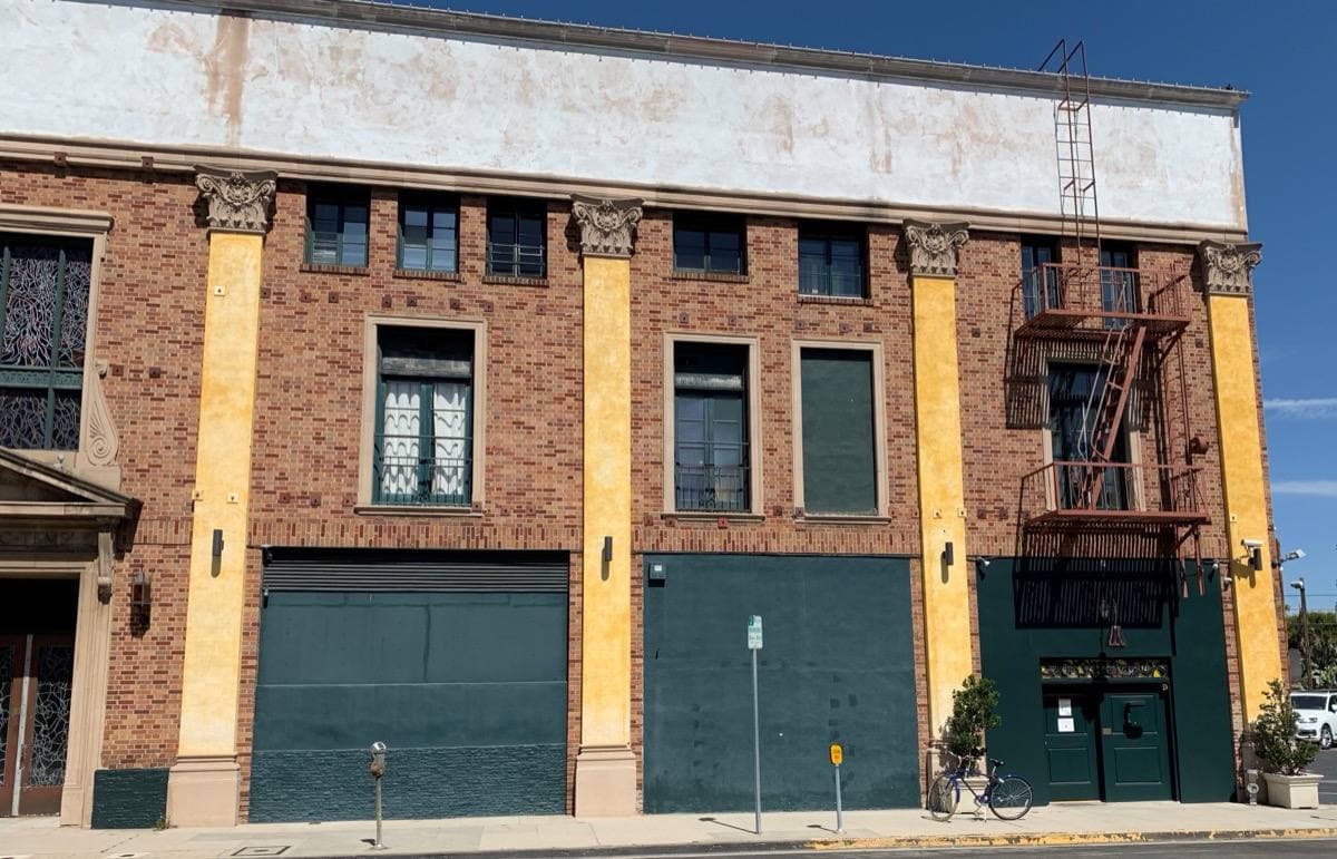 A pale studio building on a quiet Los Angeles street