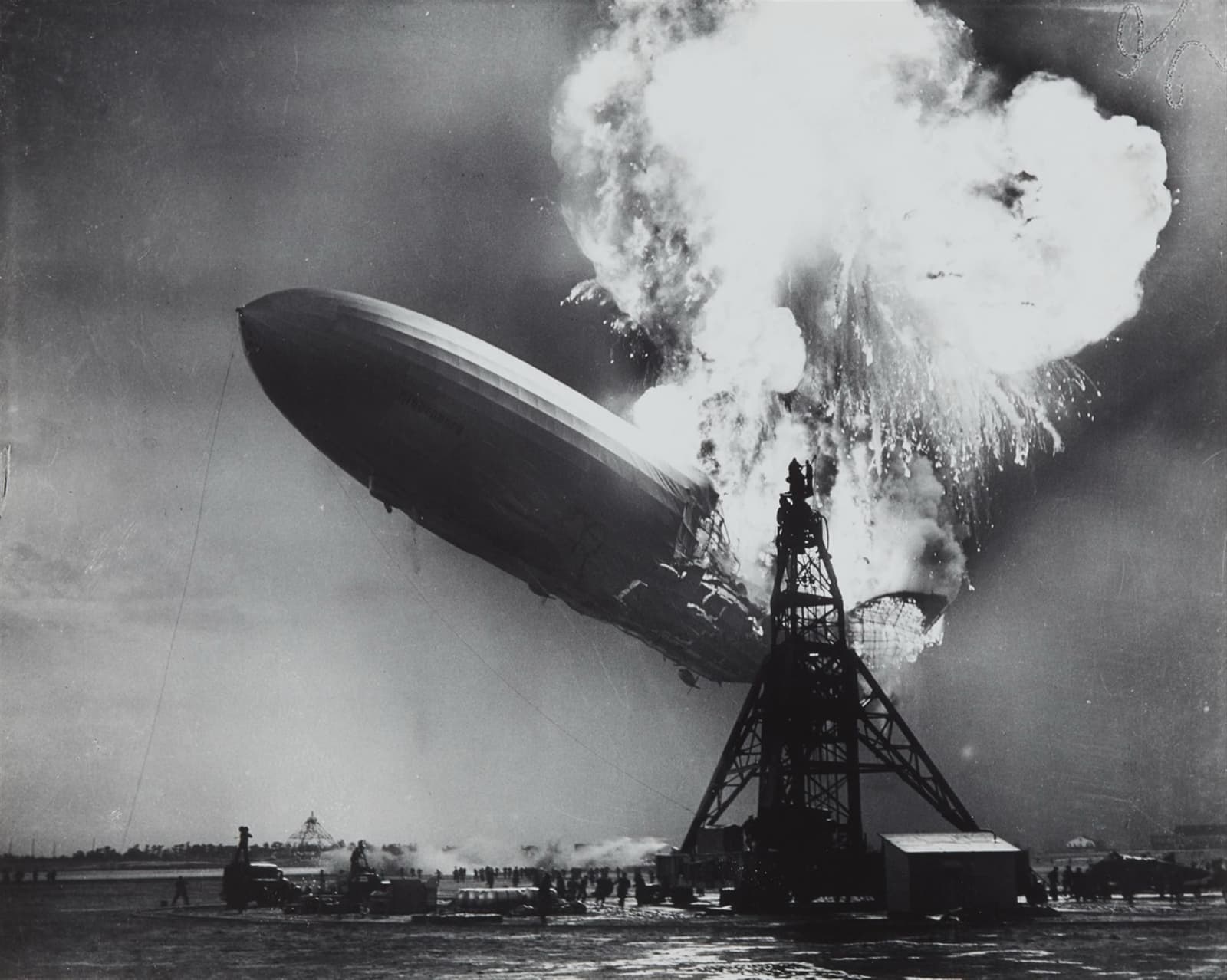 The airship Hindenburg bursting into flames over the mooring mast at Lakehurst