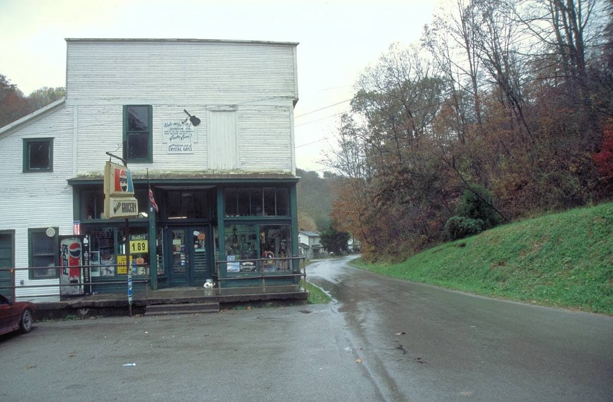 An old-fashioned country store by the roadside in a wooded valley