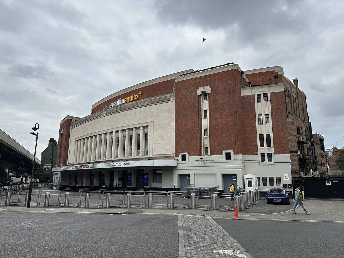 An Art Deco theatre front on a corner under a grey sky