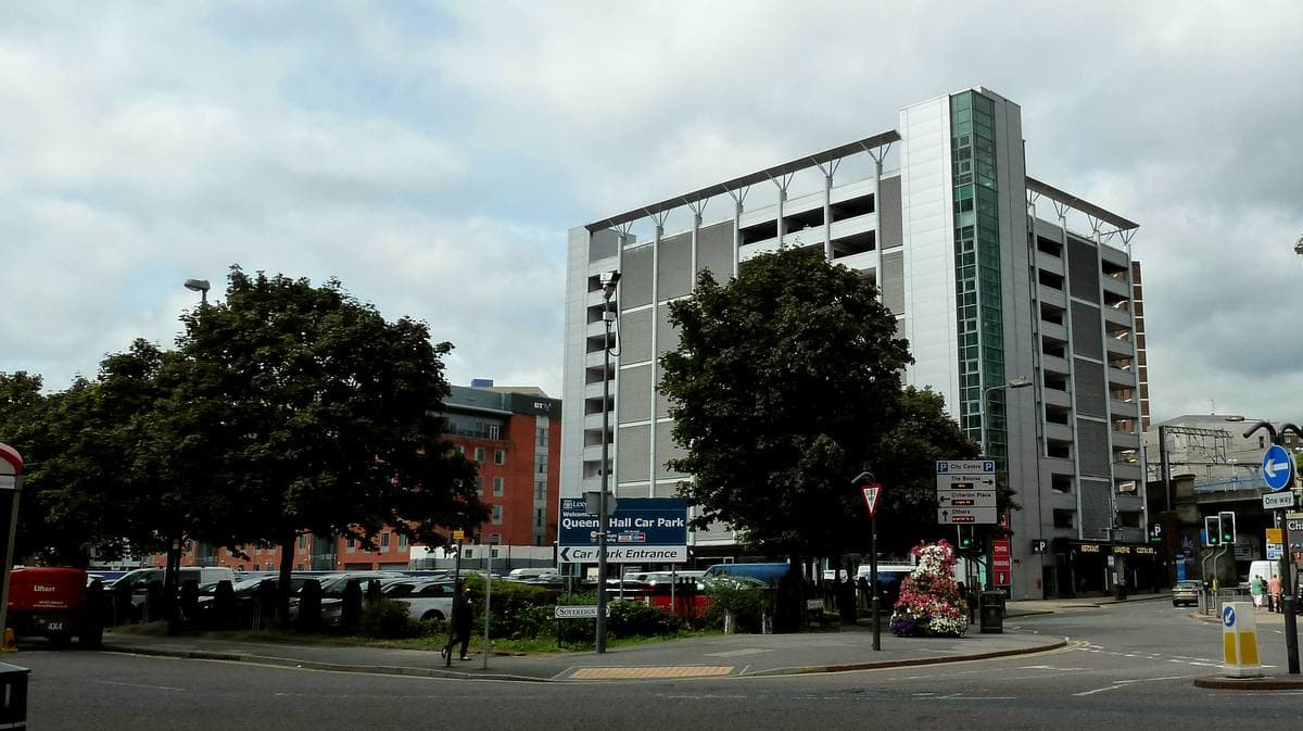 A large open car park on the former Queens Hall site in Leeds